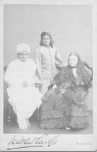 SA1318.8 - Blavatsky is wearing dark glasses and is seated by two Indians in Indian garb. Identified on the back.